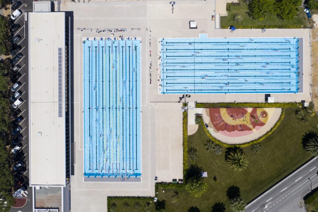 Aerial top-down view of a 50-metre competition pool and a 25-metre pool with lane lines, Antibes