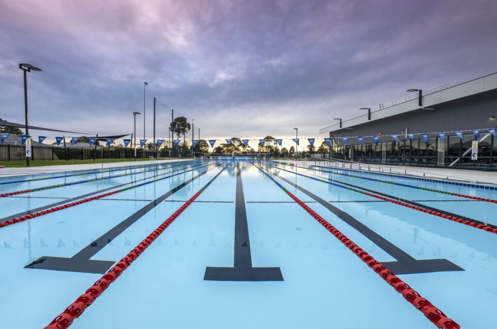 Myrtha outdoor competition pool under an evening sky, Keilor East, Australia